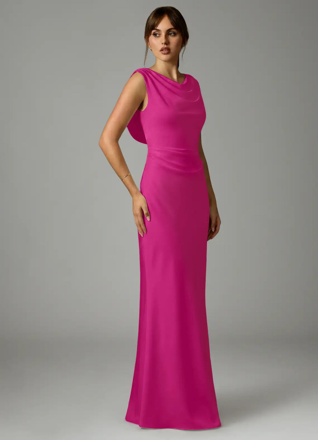 Elegant fuchsia satin bridesmaid dress with cowl neck, draped open back, ruched waist and sheath skirt