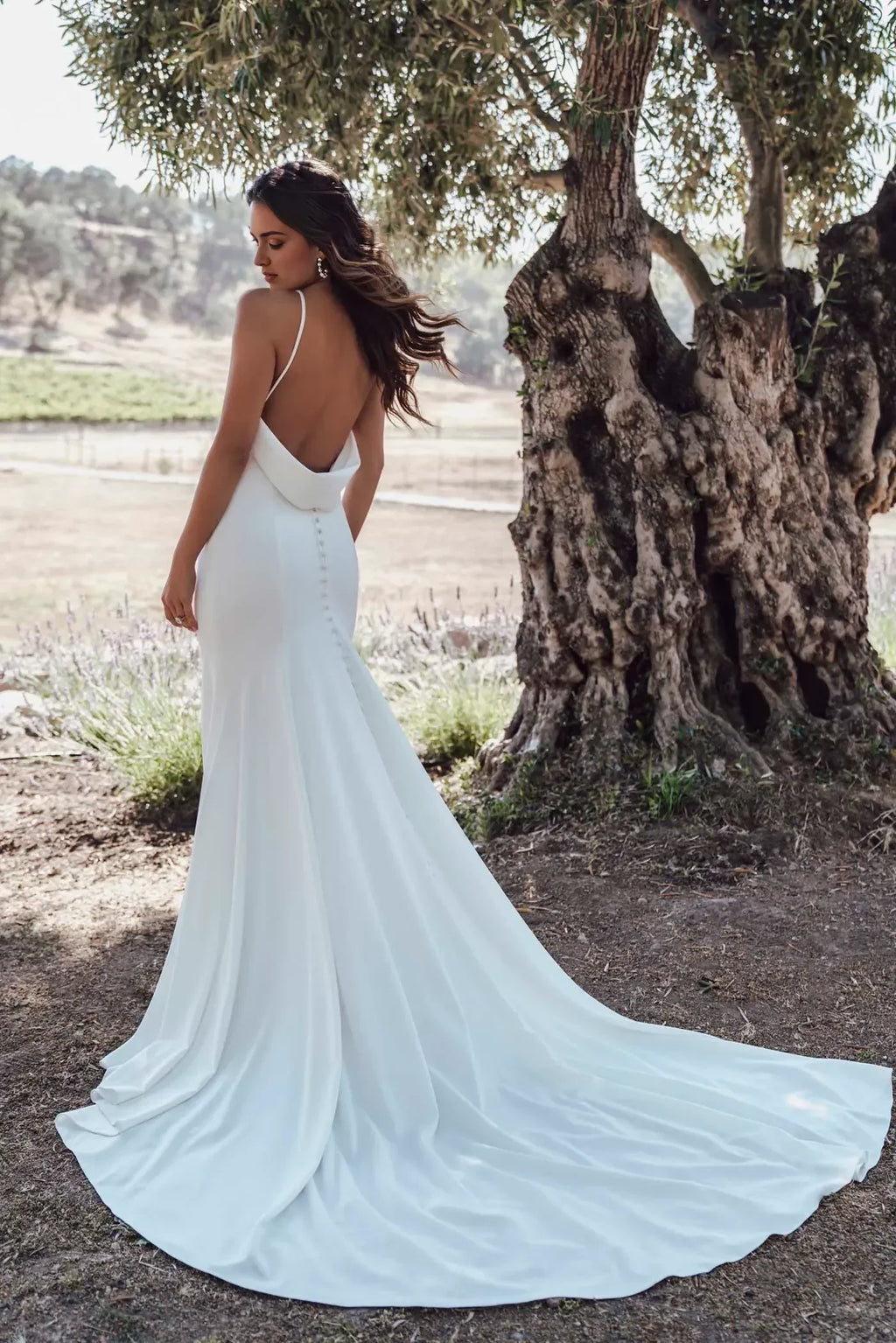 Striking Trumpet Plunging V Neck Sleeveless Cowl Back Floor Length Wedding Dress