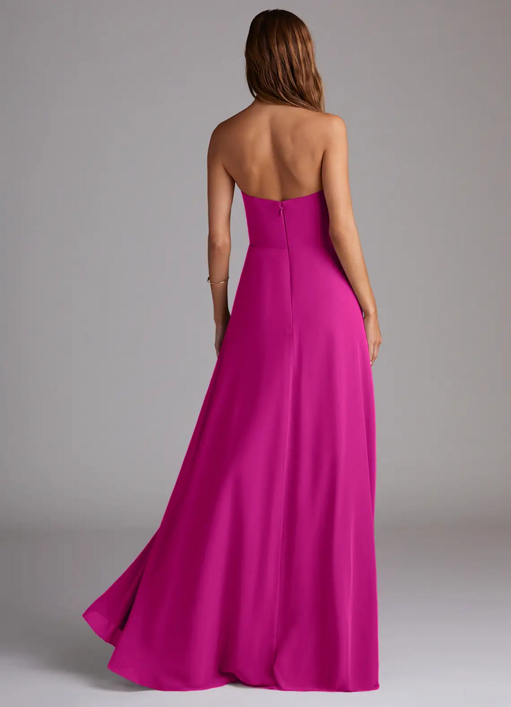 Sleek fuchsia strapless bridesmaid dress with open back, high slit and A-line skirt